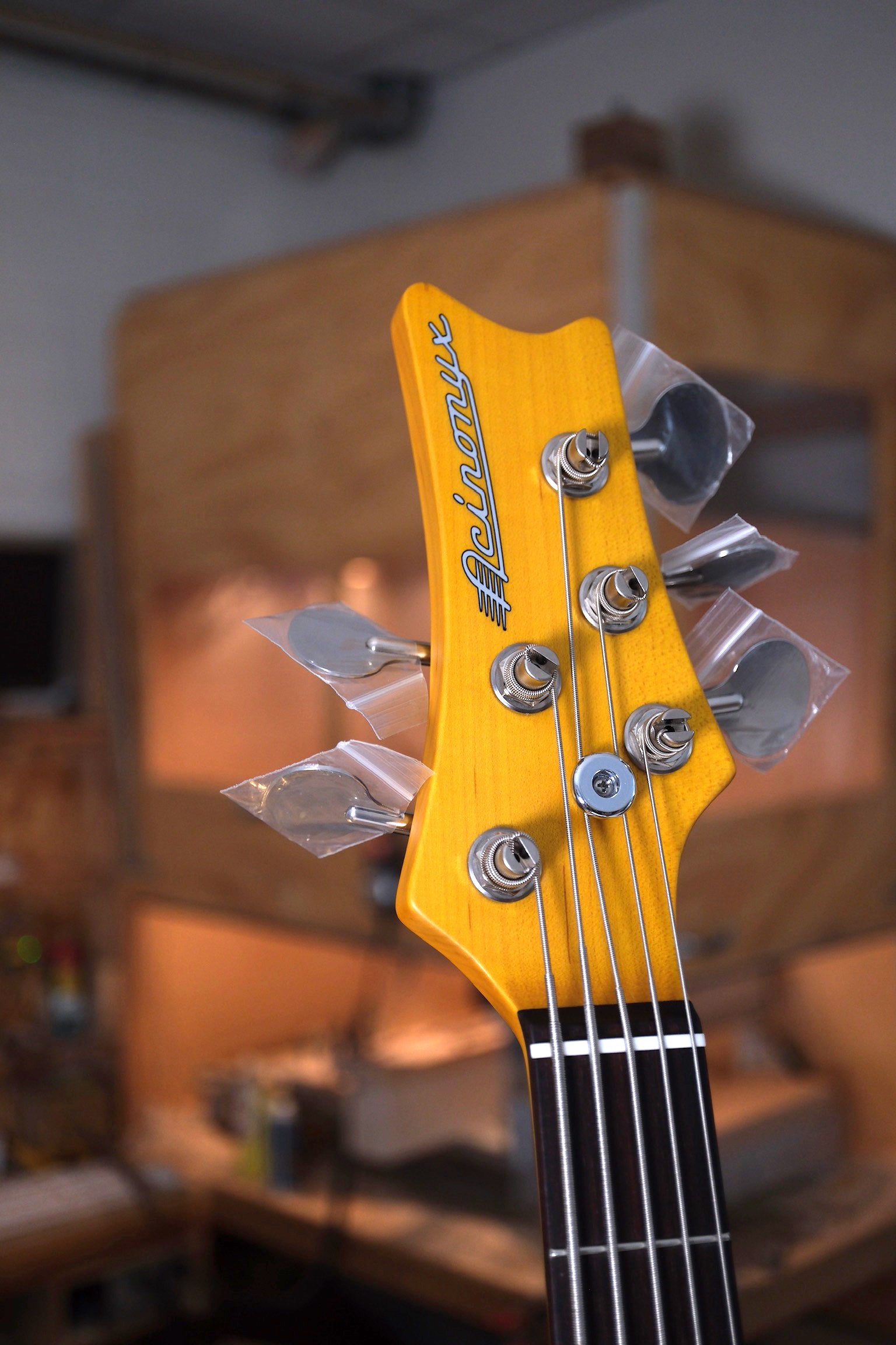 front photo of the headstock of the Acinonyx V Short Scale Bass Guitar - Championship Sparkle Blue