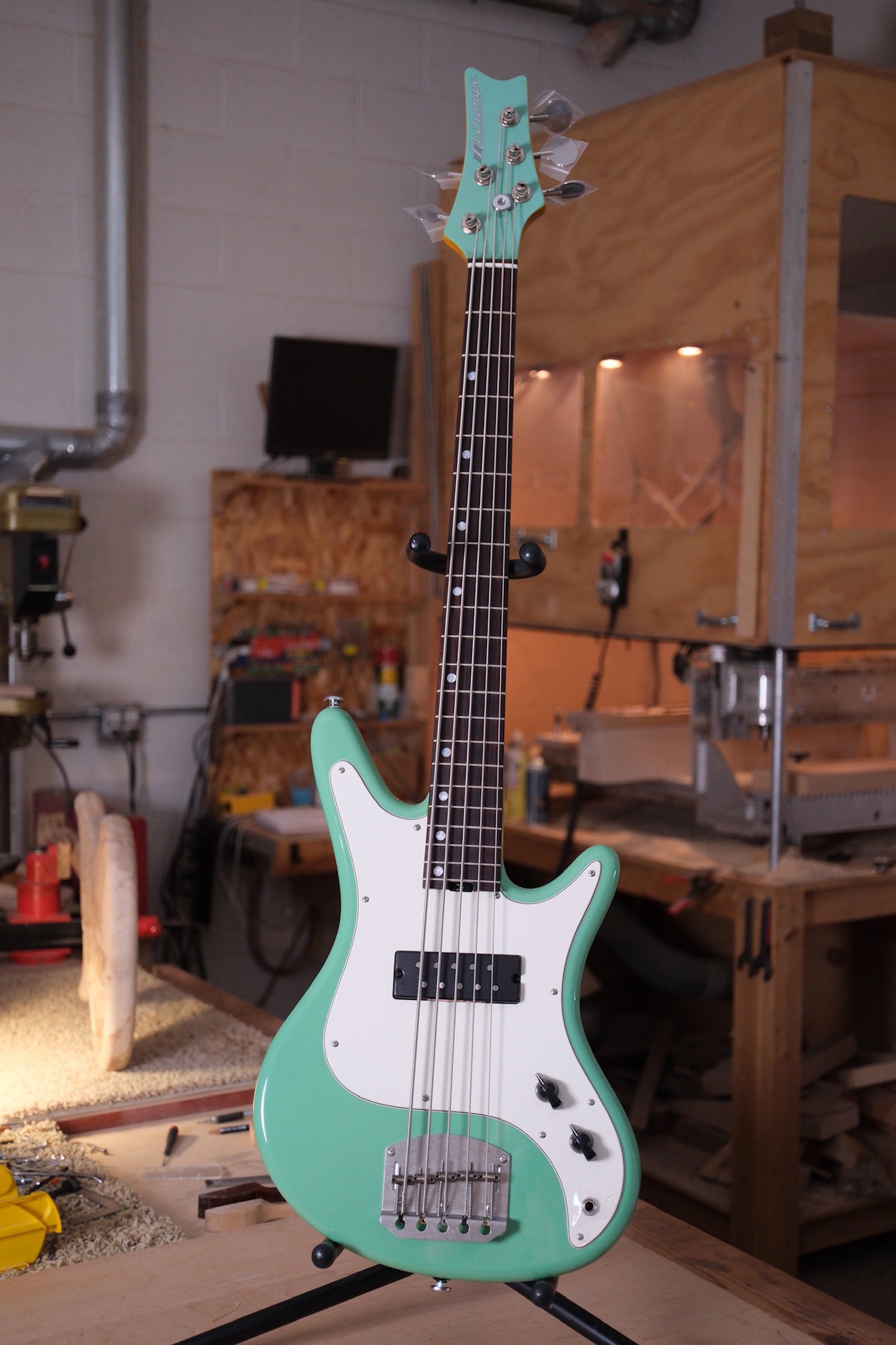 front photo of the whole bass of the Acinonyx V Short Scale Bass Guitar - Seafoam Green showing the matching green headtock