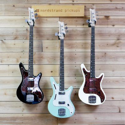 Front view of Nordstrand Acinonyx Basses Hanging on wall