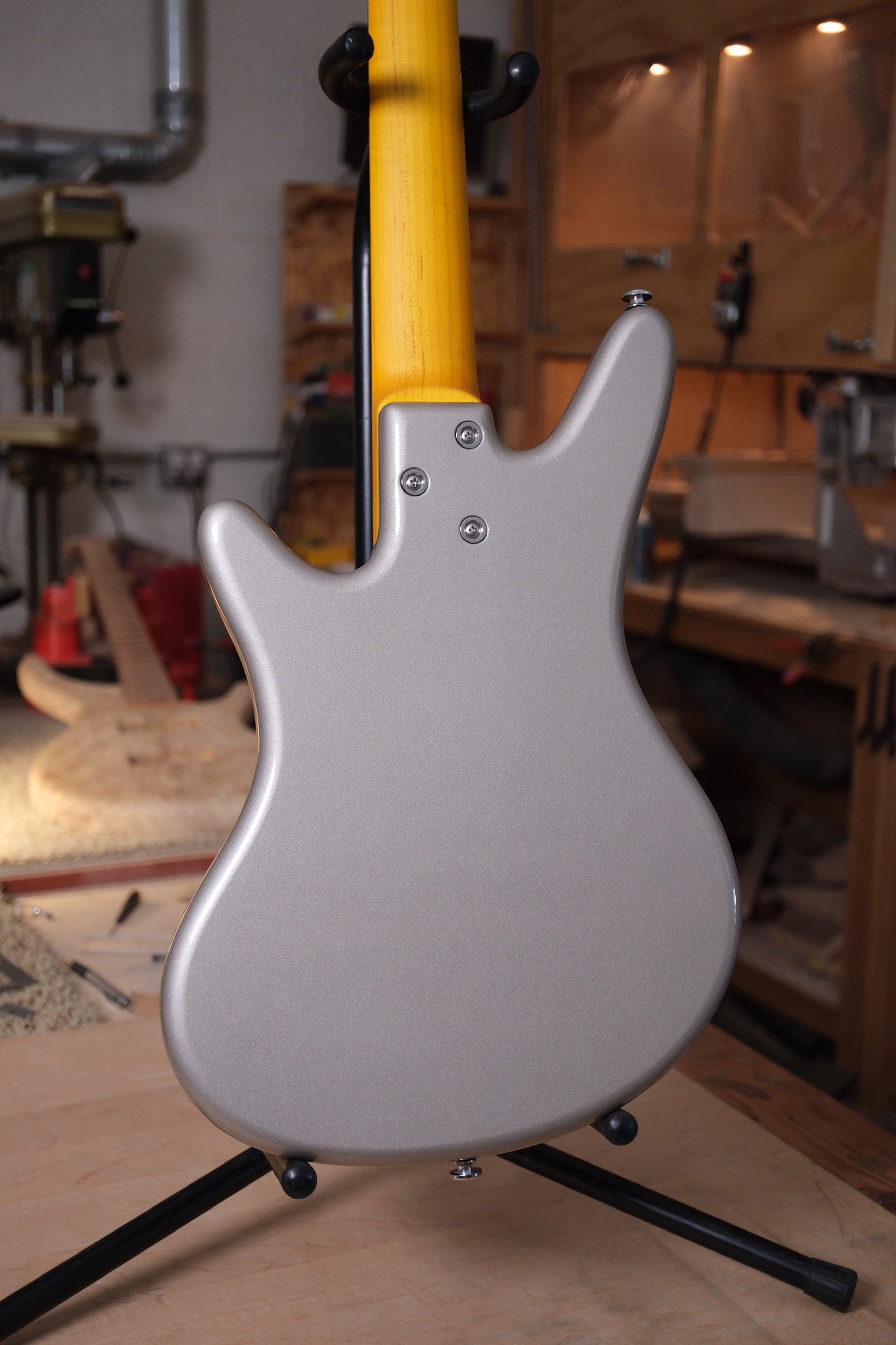 back side of body photo of the Acinonyx V Short Scale Bass Guitar - Inca Silver showing the 3 bolt connection