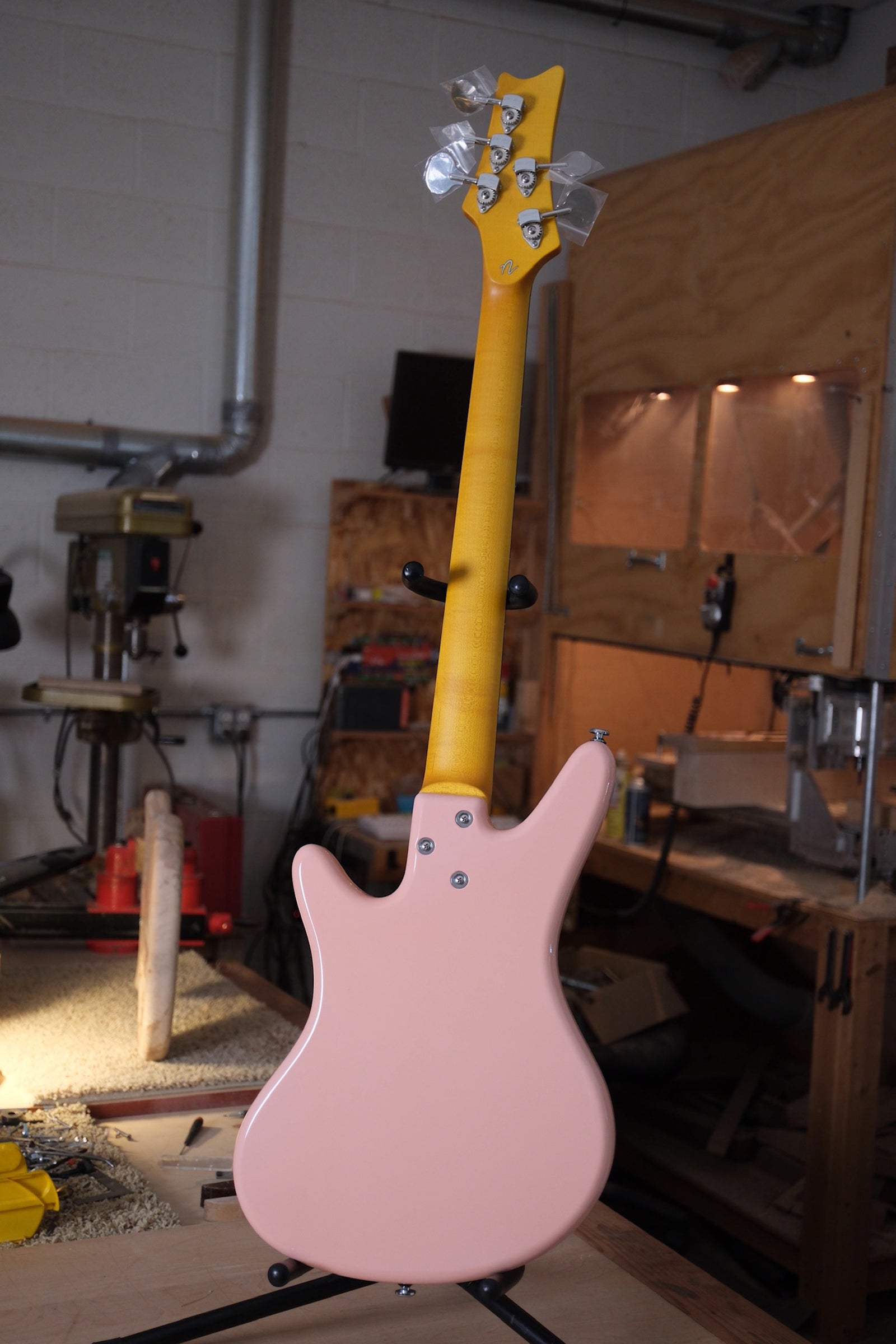 full back photo of the Acinonyx V Short Scale Bass Guitar - Shell Pink showing the aged maple looking neck