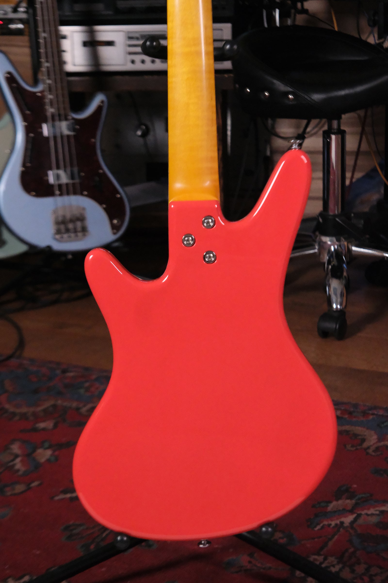 Back view of the body of the Acinonyx V - Fiesta Red bass guitar showing the 3 bolt attachment