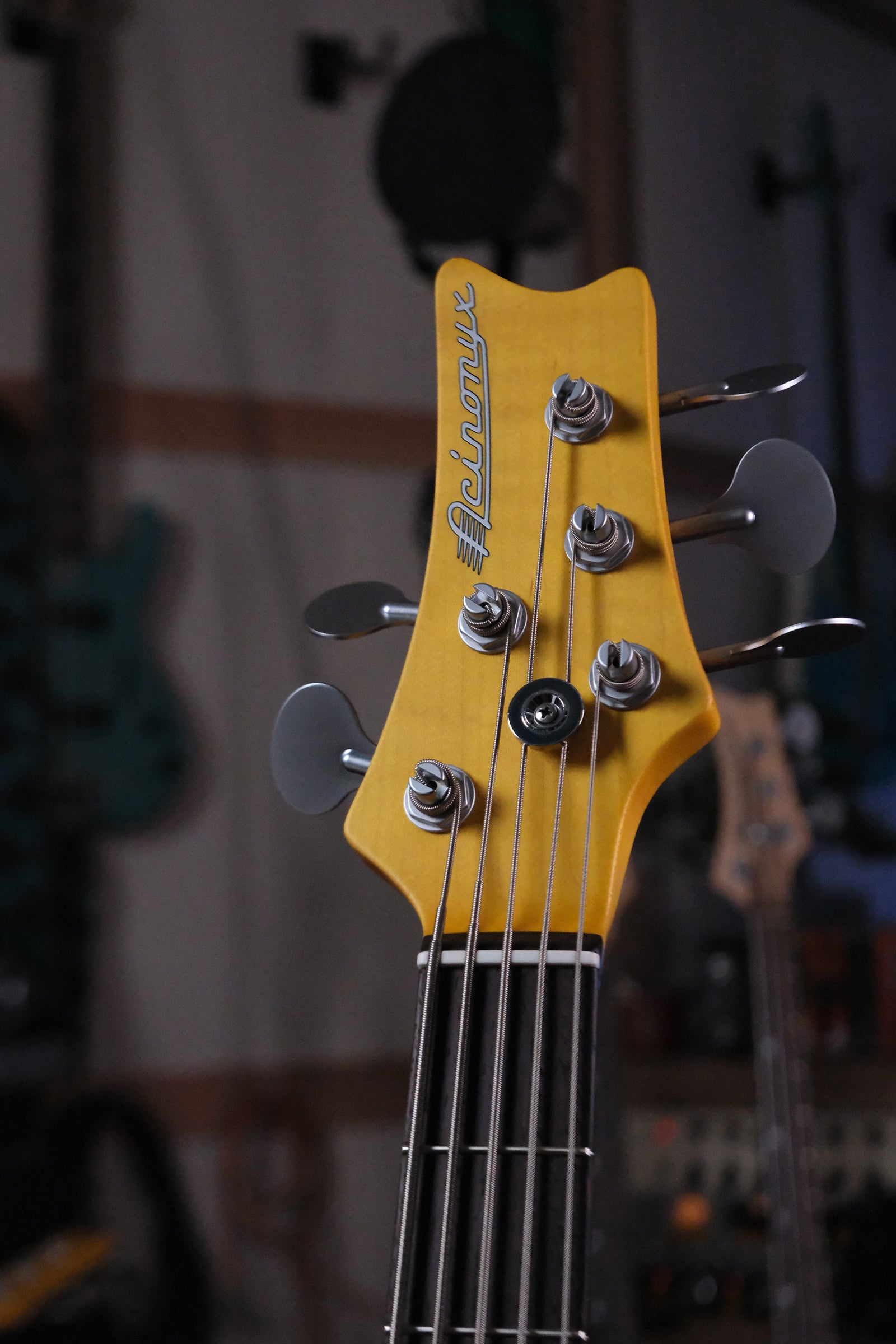 front headstock view of the  Acinonyx V - Surf Green bass guitar