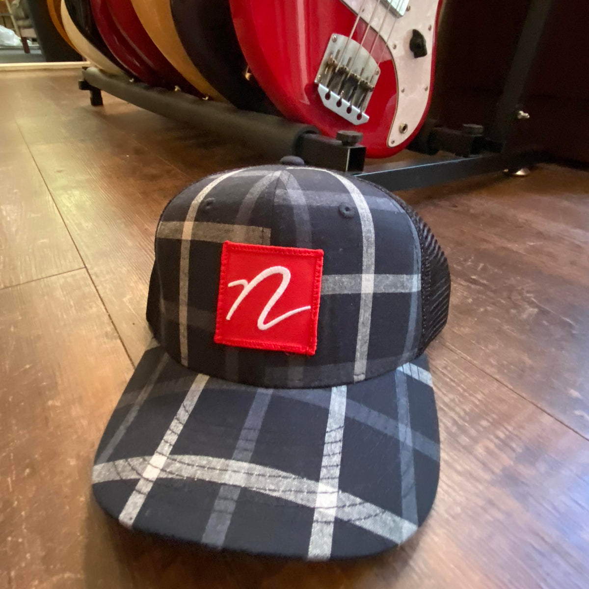 Front view of Nordstrand N Logo Plaid Trucker Cap in Black